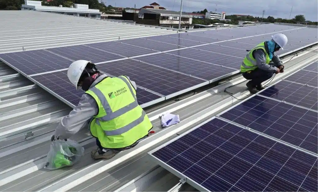 A Bright Solution team is installing solar panels on a commercial roof in London