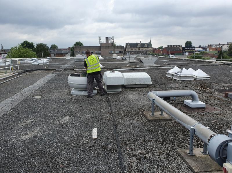 A Bright Solution mechanical team installs a HVAC system on the roof of a supermarket in London