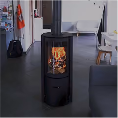 Modern black wood-burning stove with visible fire in a spacious room with tiled floor and contemporary furniture.
