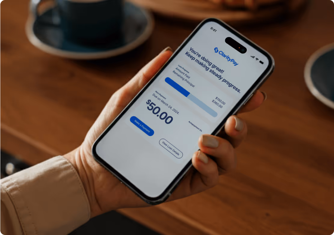Man holding iPhone with ClarityPay app open