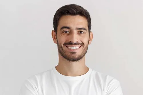 A man with a goatee smiles at the camera.