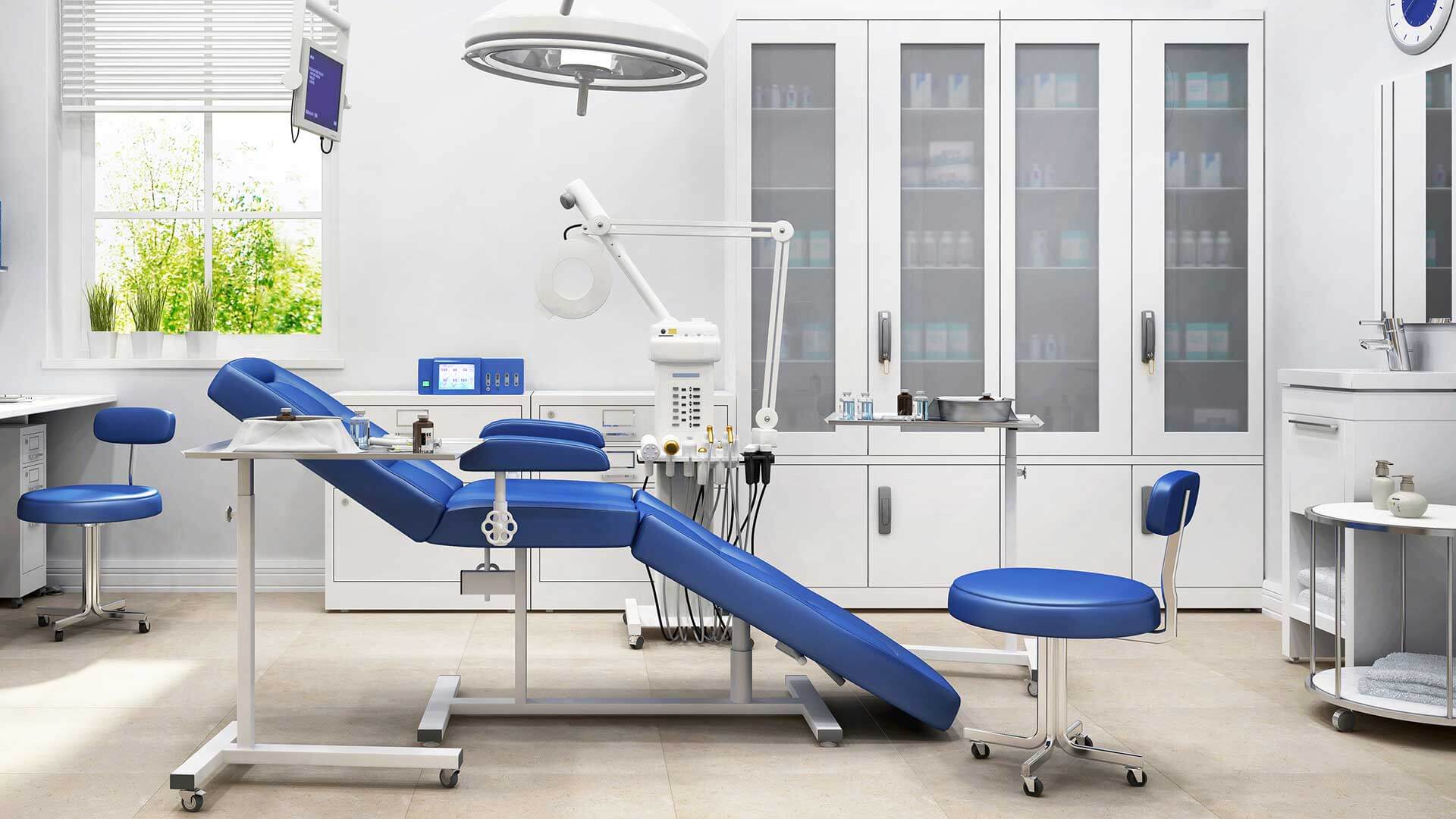 A dentist's office with blue chairs and a desk.