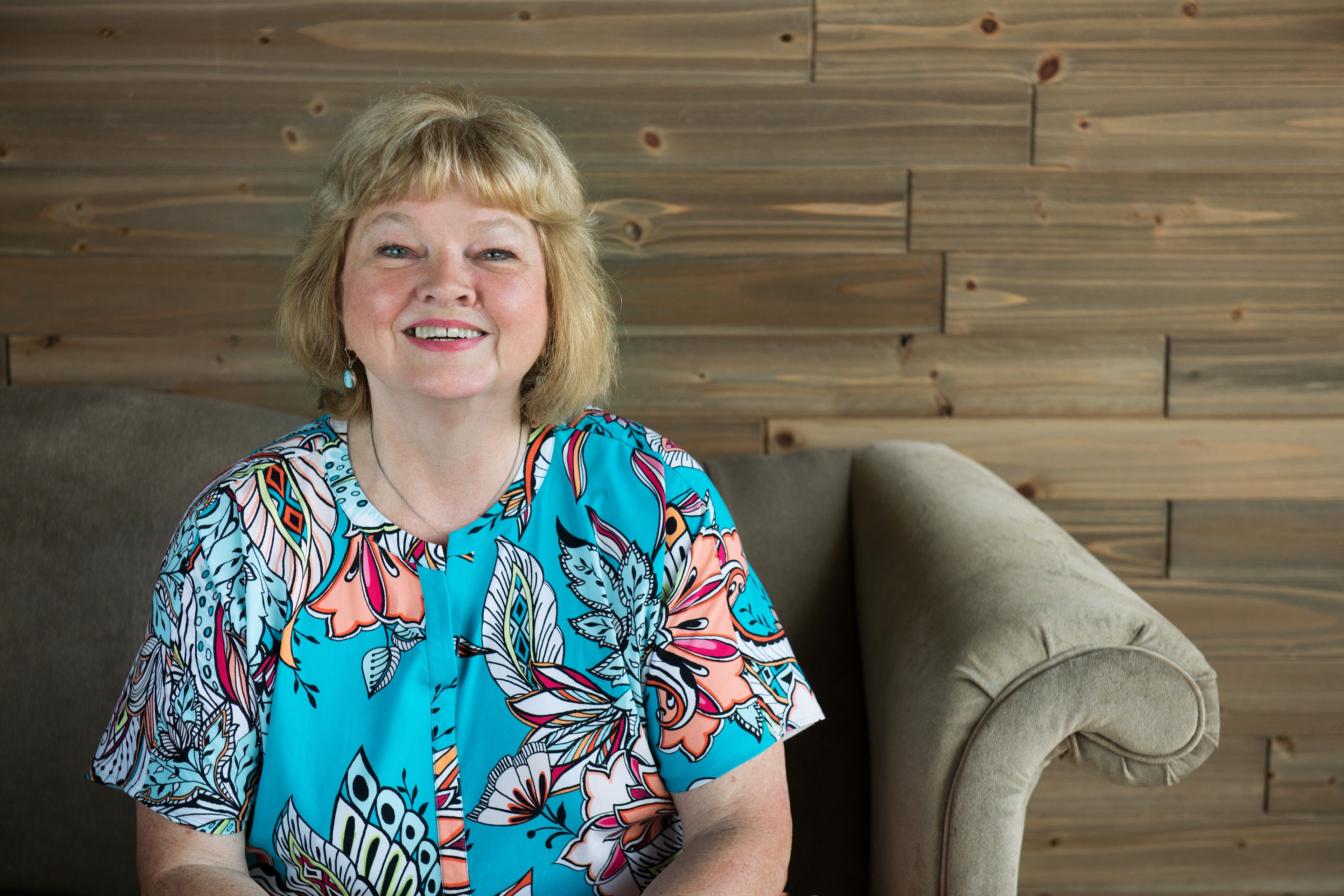 Medium shot of a smiling woman.