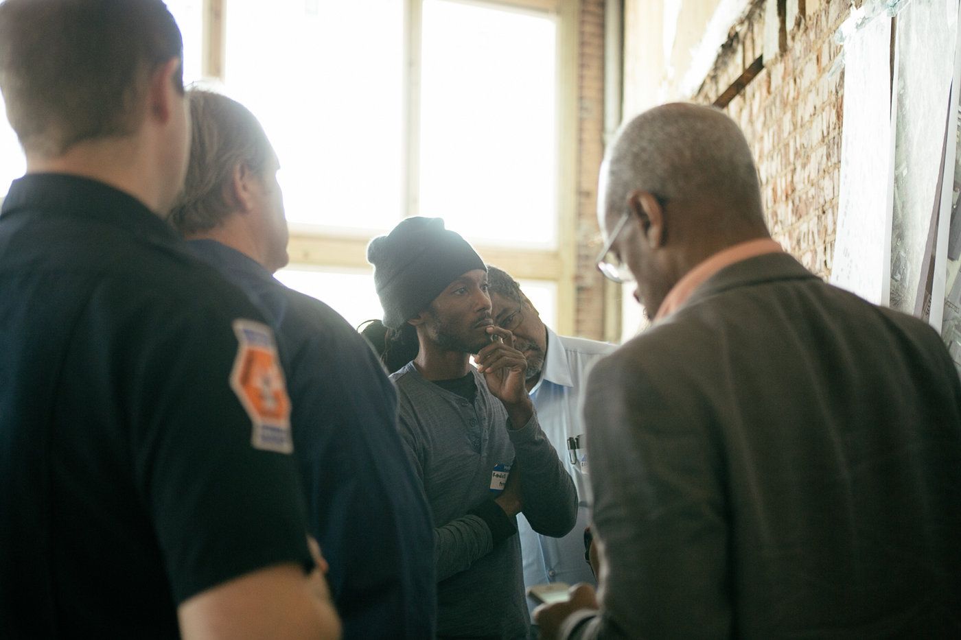 A medium shot showing a gathering of men at an event.
