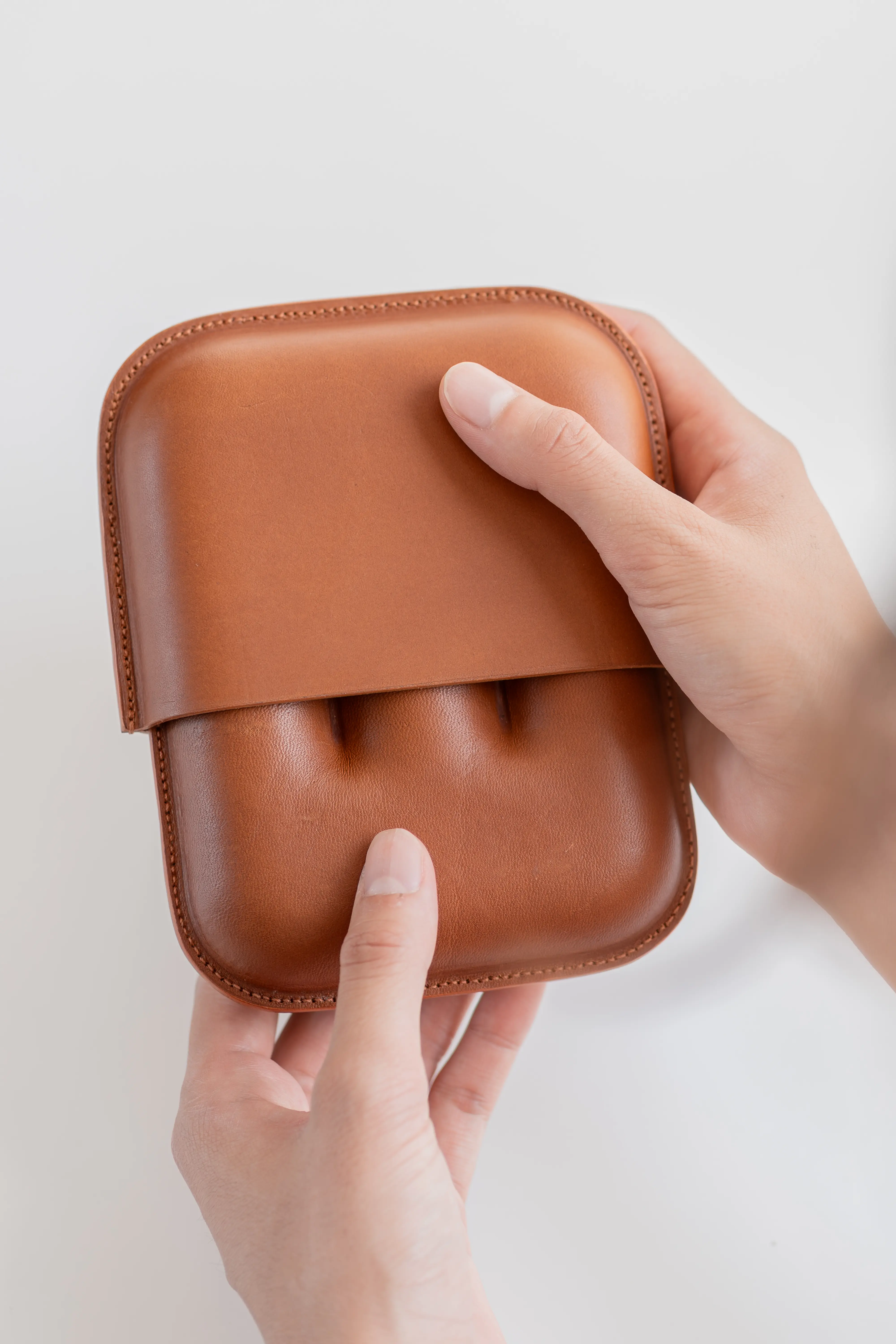 Person removing lid of case