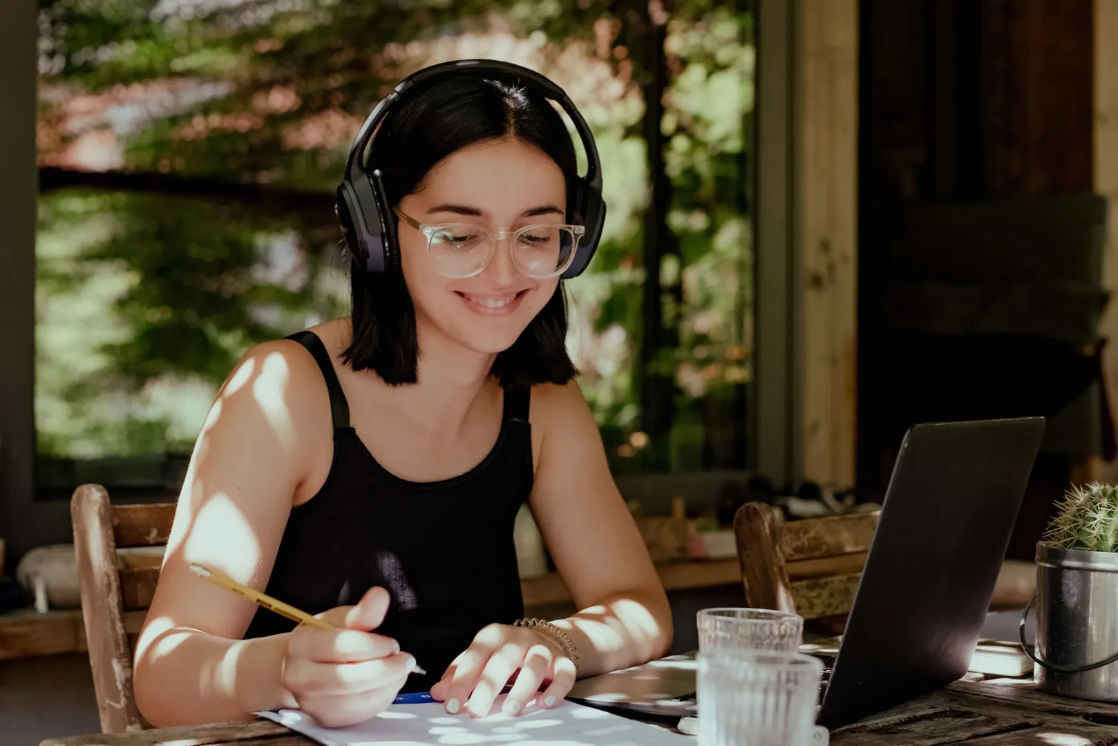 A focused girl working diligently in a well-lit office space.