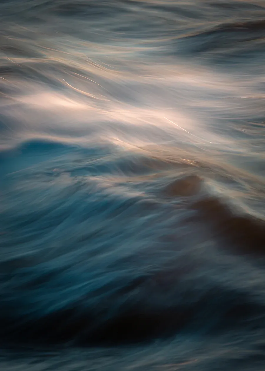 calming ocean waves with morning light reflections.