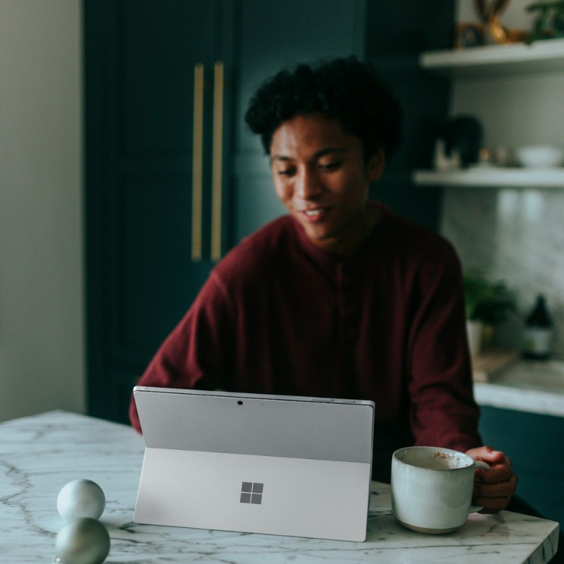 Leader at a laptop representing Authenticity, one of LeadIN's 3 Signature A's