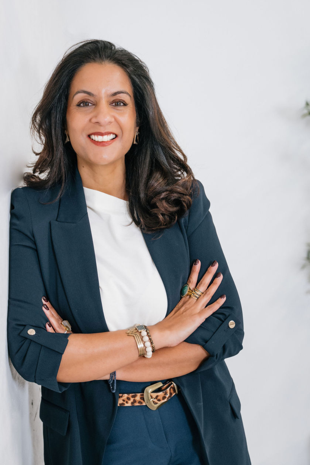 Raj Anderson, Founder and CEO of Coachability, smiling with arms folded