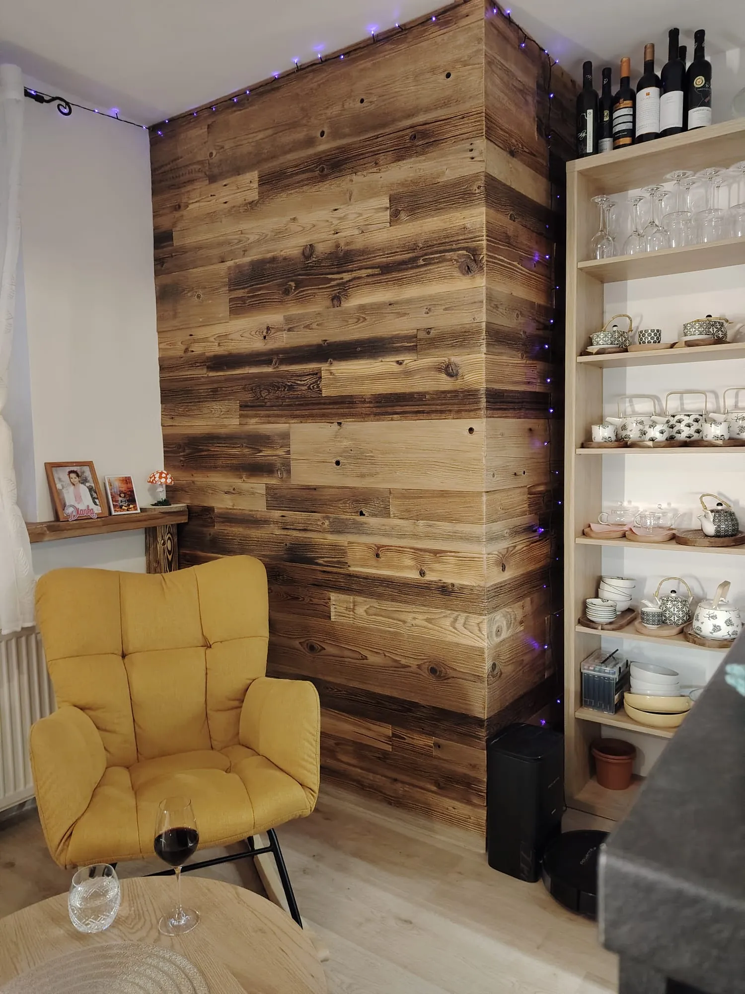 Corner in the restaurant with wooden wall and yellow armchair