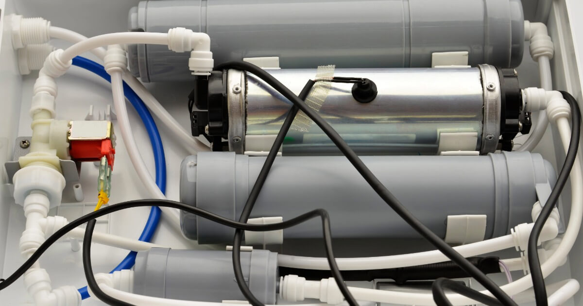 UV water filtration system with multiple filters and tubes in a compact setup.