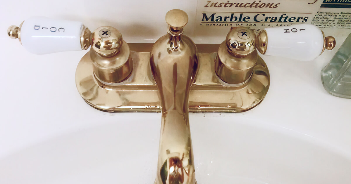 Gold faucet with cold handle on the left side