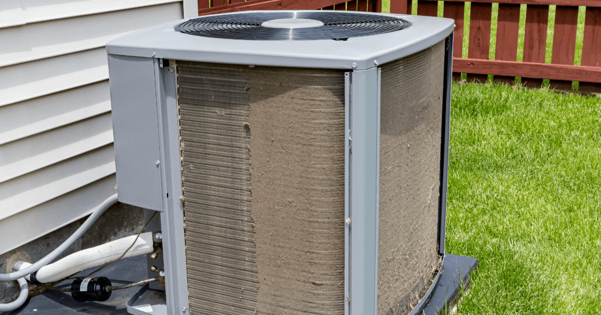 Dirty outdoor air conditioning unit in backyard. 