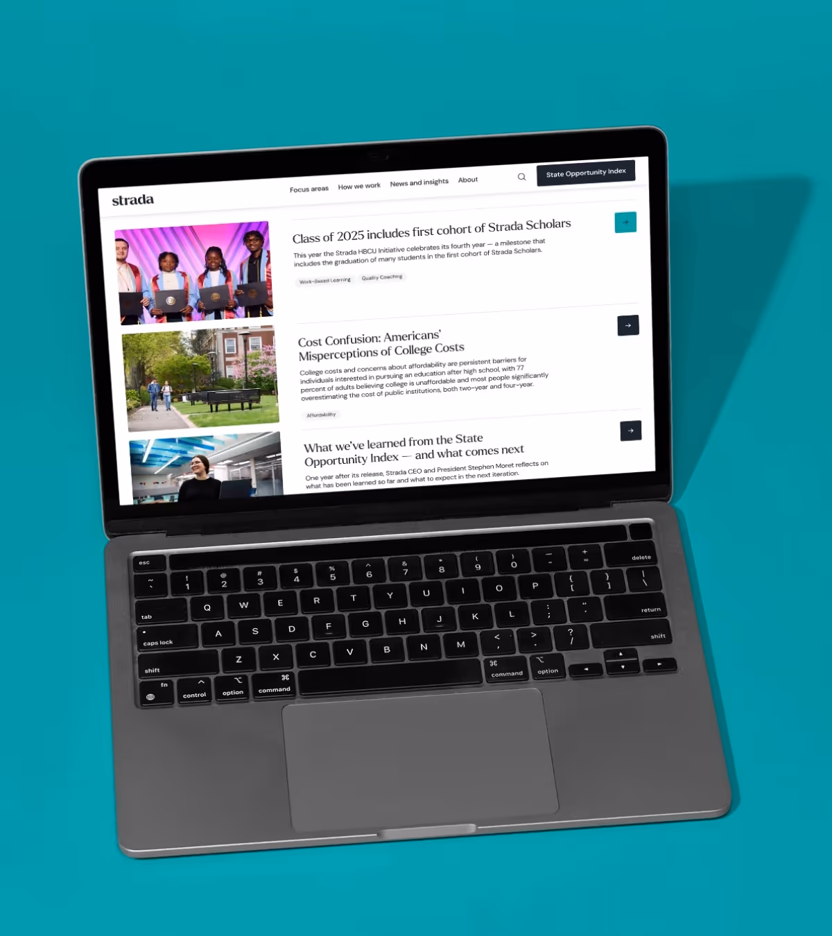 Open laptop displaying Strada website with articles on education topics including the Class of 2025 Strada Scholars and college cost misconceptions.
