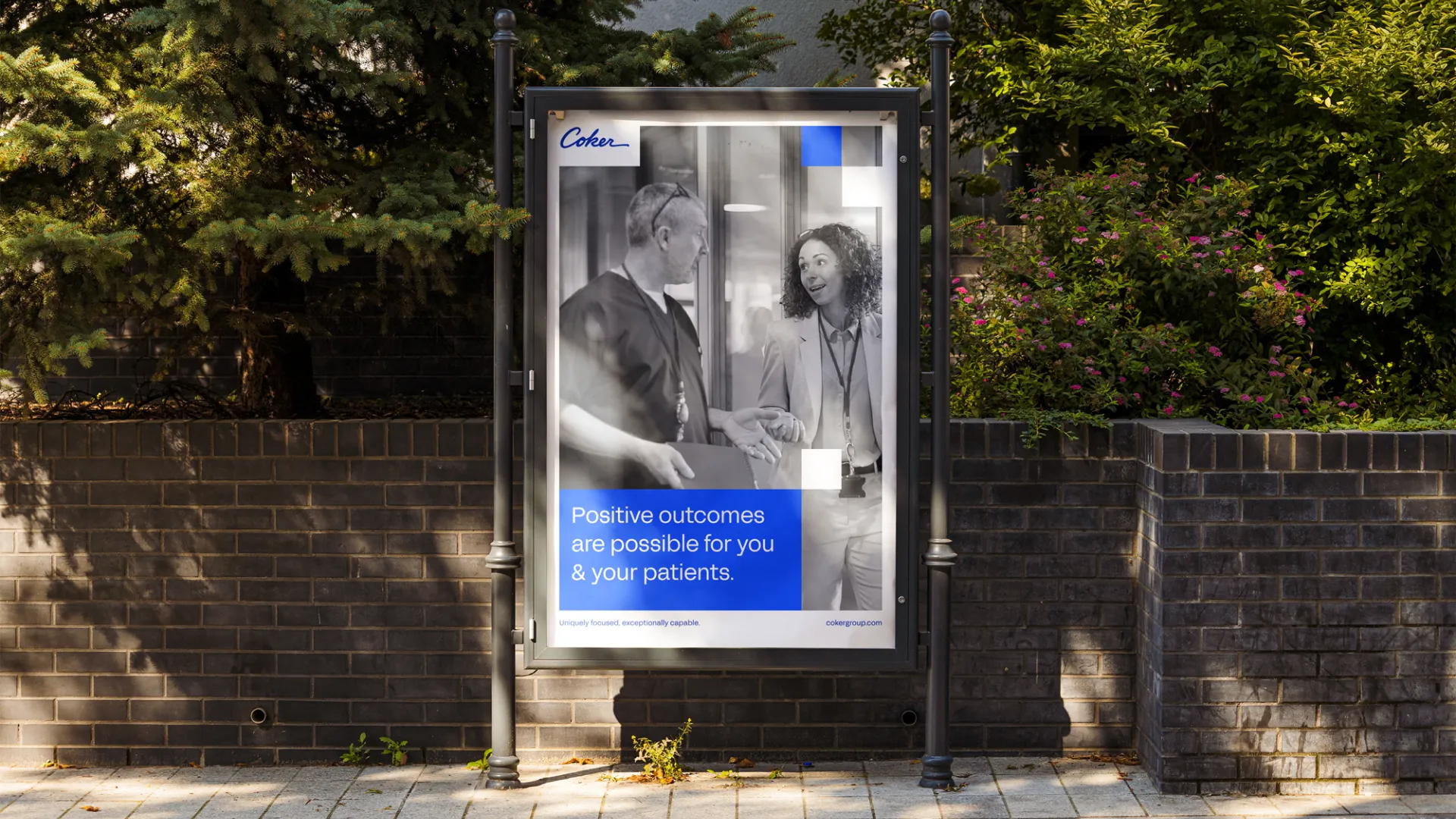 Outdoor vertical sign showing two medical professionals talking with text: Positive outcomes are possible for you & your patients.