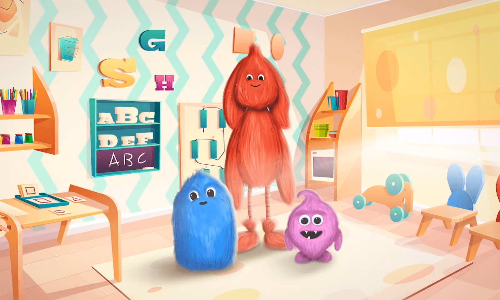 Three colorful furry monster characters in a bright, playful classroom with alphabet letters and toys.