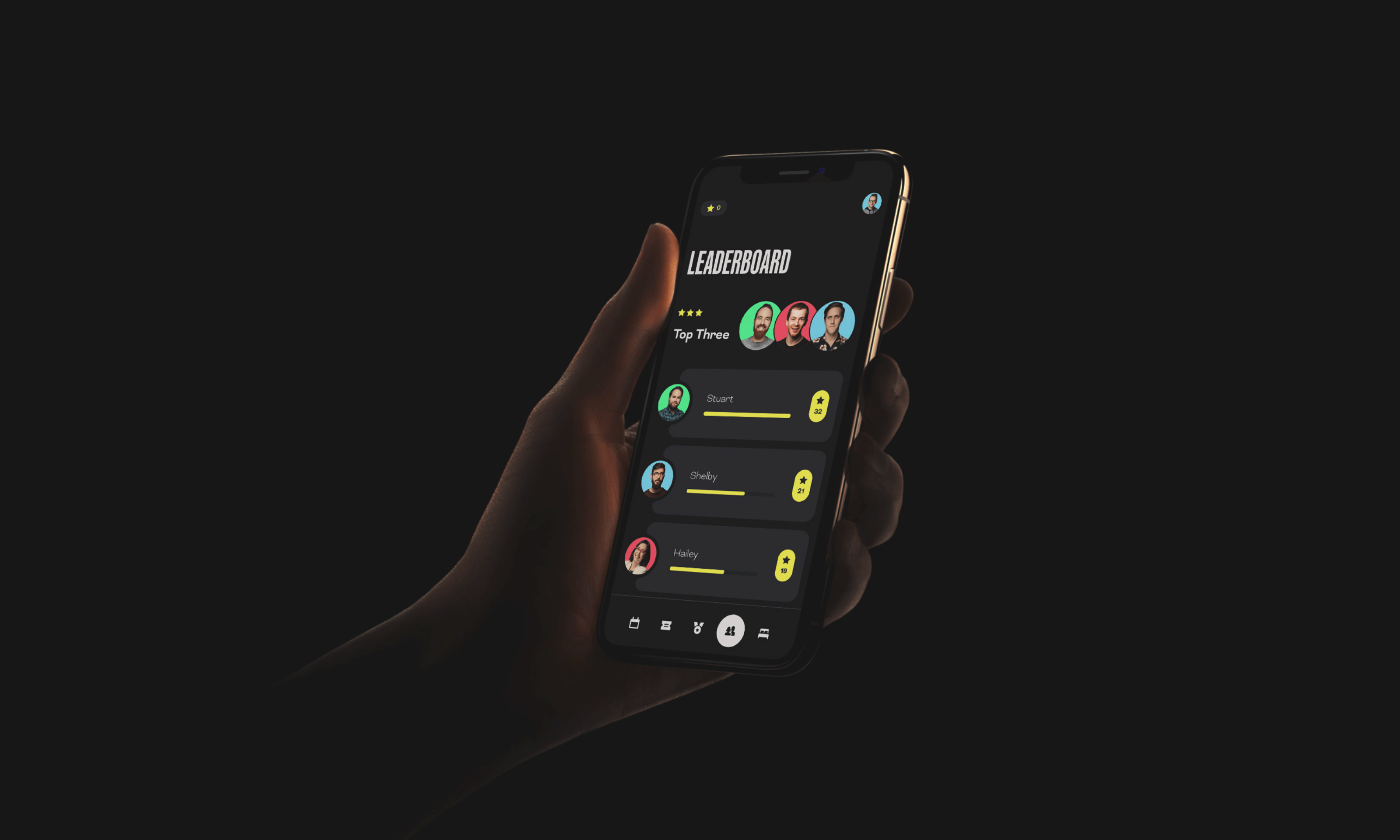 Hand holding a smartphone showing a leaderboard app screen with user photos and scores for Stuart, Shelby, and Hailey.