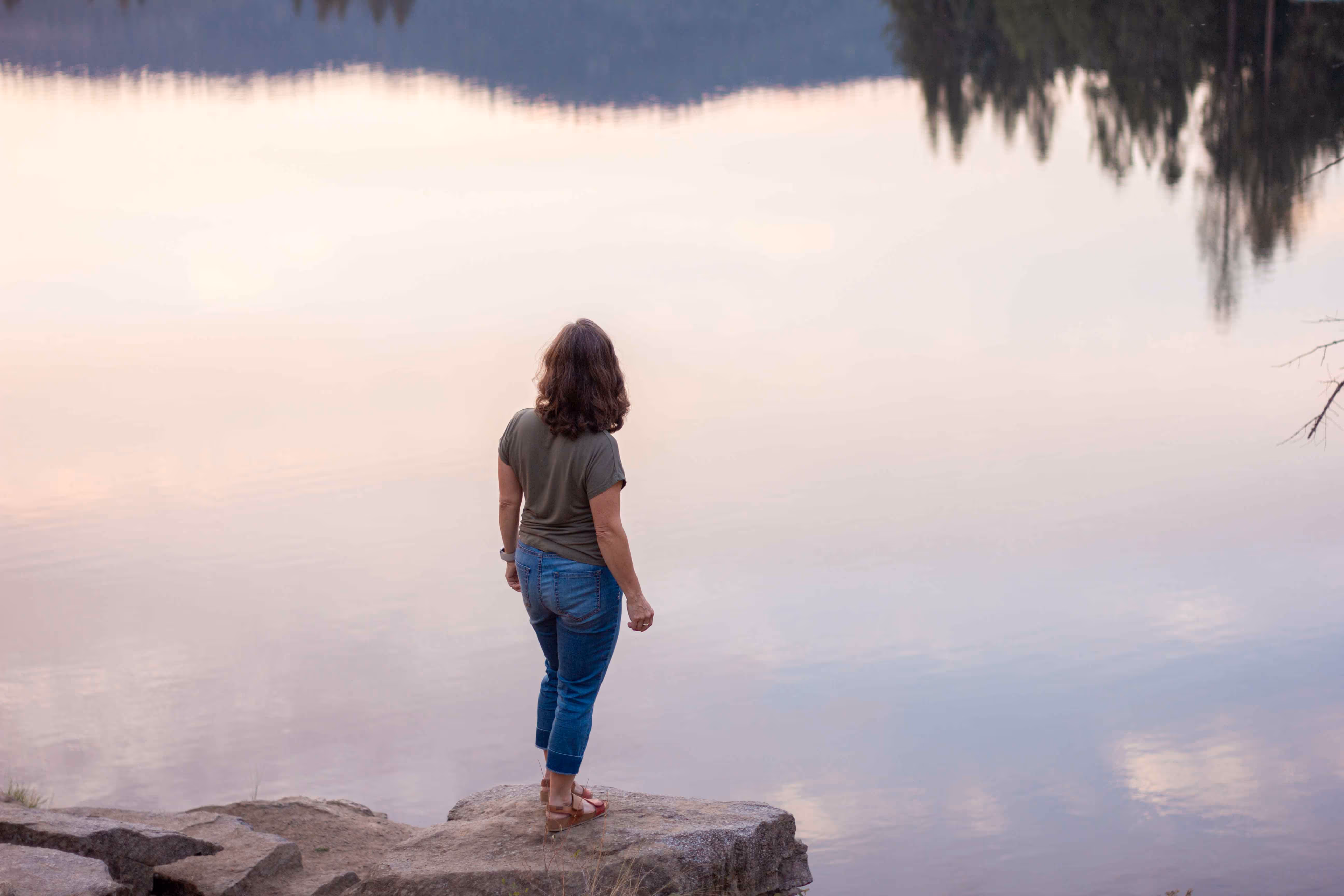 Digital Socrates founder Patti Hinman facing away from camera looking out at lake.