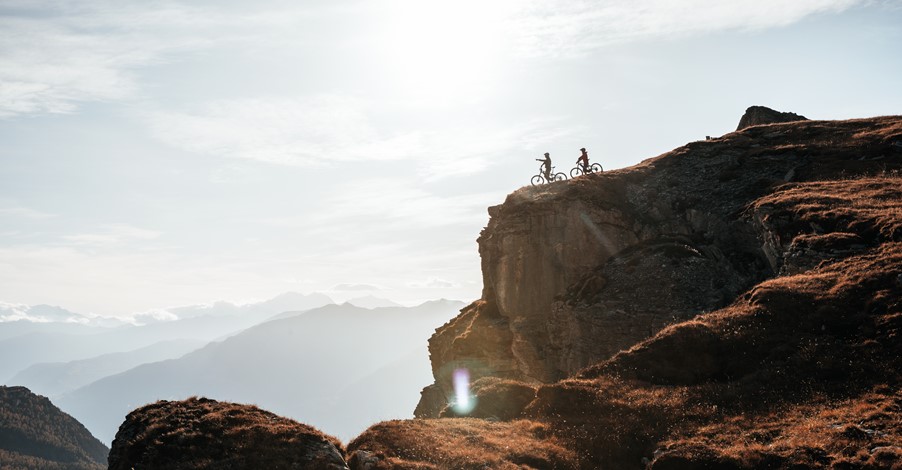 Riders admiring the stunning views of the Rhone Valley from Crans Montana during the e-MTB UNESCO Haute Route
