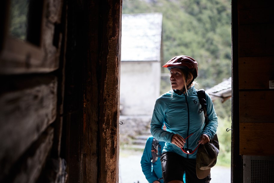 Woman mountain biker exploring a typical Swiss Mountain Village