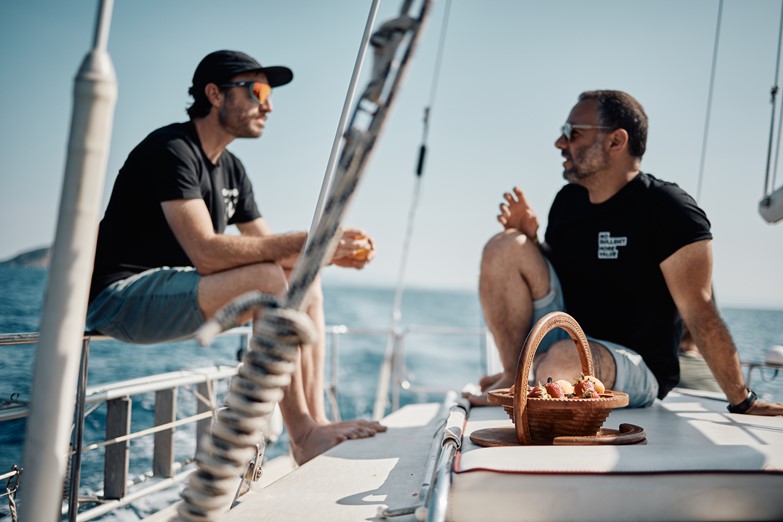 Relaxing on our sailboat with a view of Elba Island in the horizon