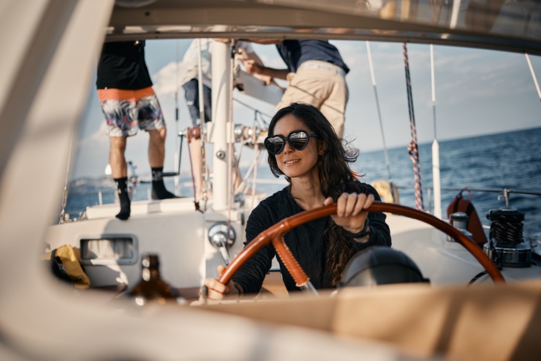 Clients navigating the sailboat during our Tuscany Sail 'n Trails adventure