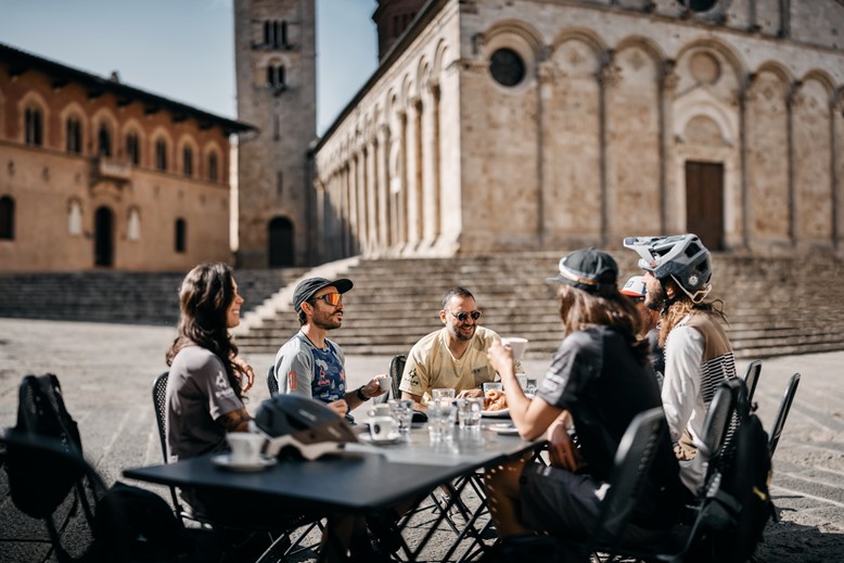 Enjoying a capuccino in Massa Maritima's piazza surrounding by medieval buildings
