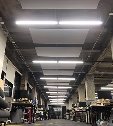 A room with a lot of furniture and a lot of lights.