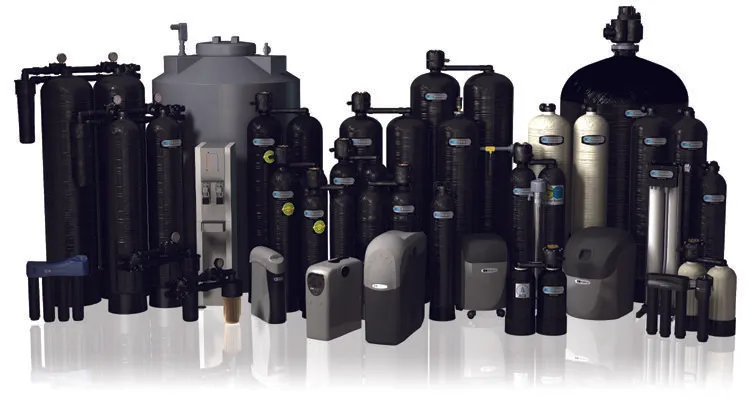 Variety of black and grey water filtration and softener tanks of different sizes arranged in a group.