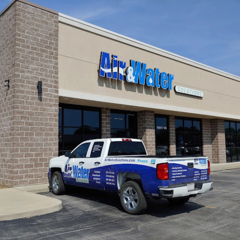 A truck with "Air & Water Solutions" branding is parked in front of a matching storefront