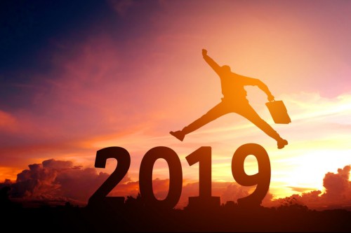 2019 with man jumping excited in sunset