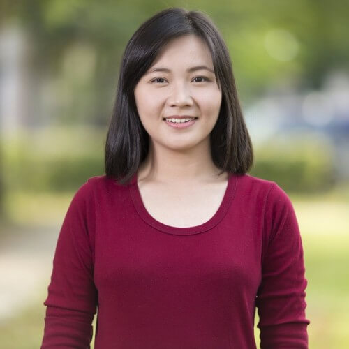 woman smiling outdoors looking relieved