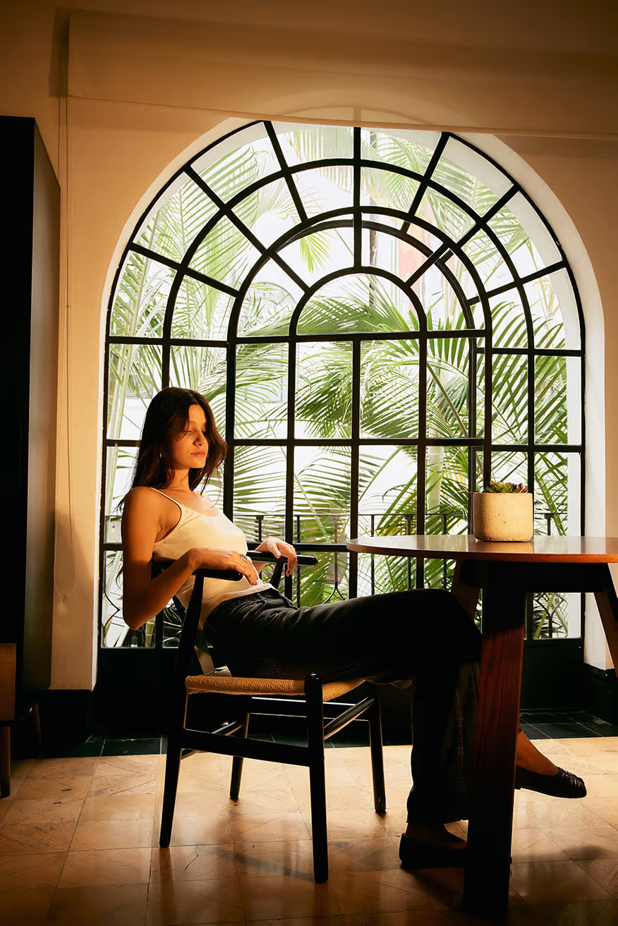 A serene morning view in a room, a woman is drinking coffe. 