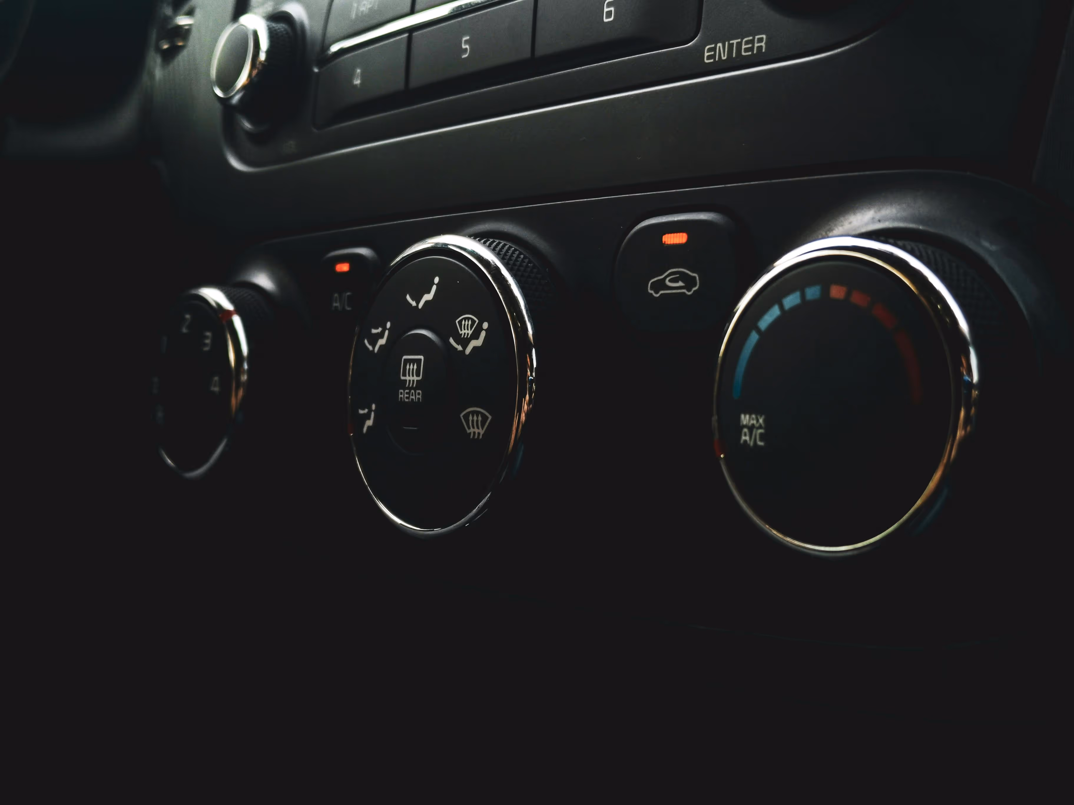 A close-up of car's interior climate control panel.