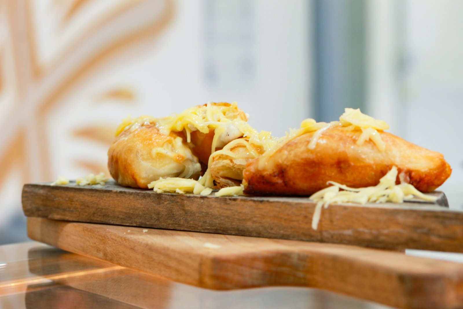 Burger with fried fries on black plate with sauce on the side