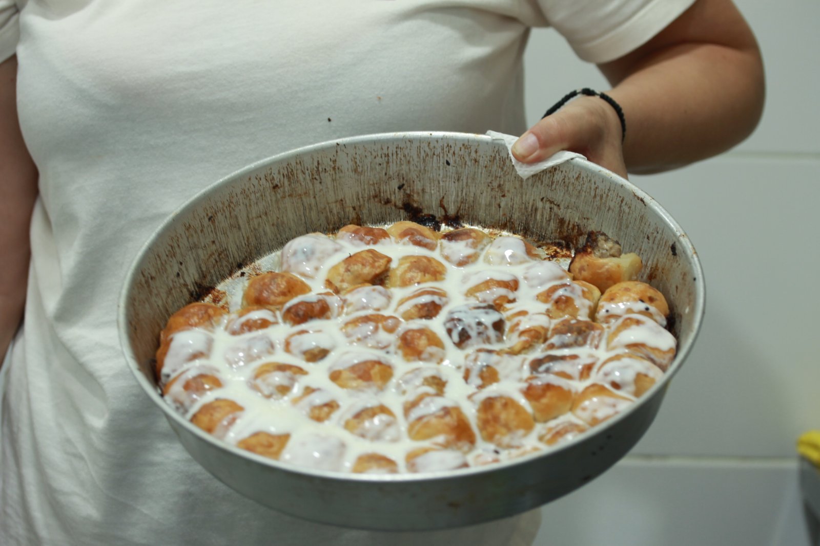 Burger with fried fries on black plate with sauce on the side