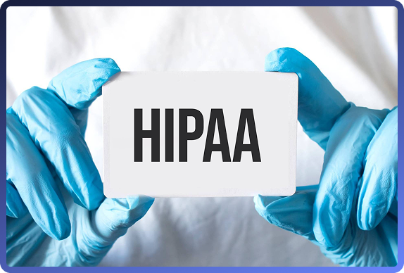 Blue-gloved hands holding a white card with the word HIPAA printed on it