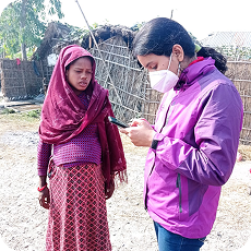 Field worker with community member
