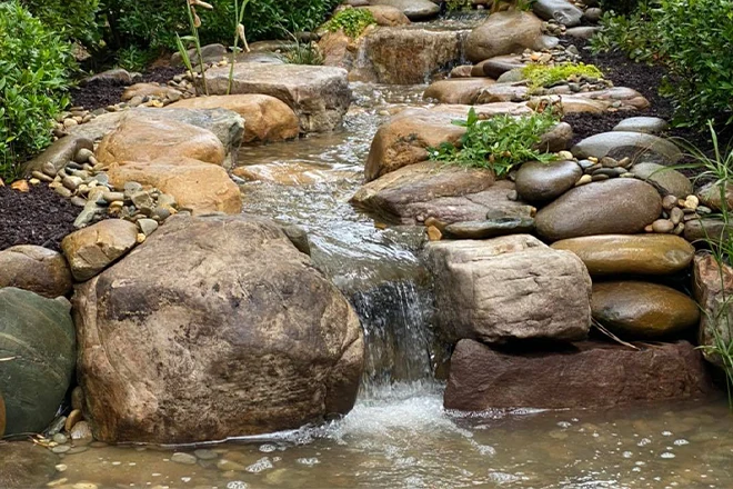 Stream and waterfall addition to a pond
