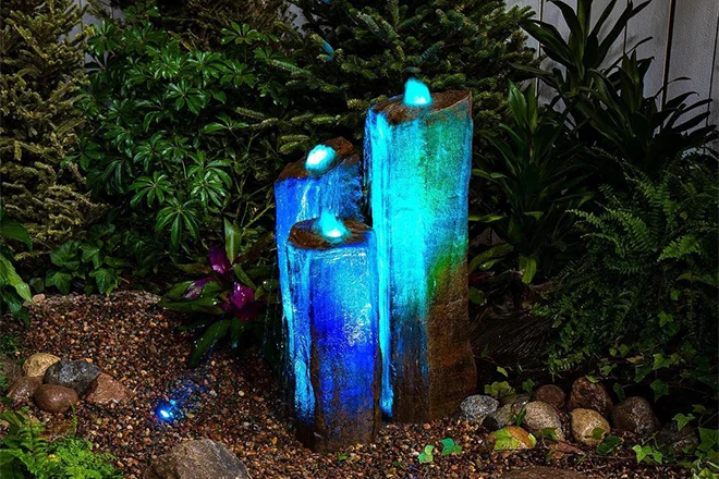 Beautiful blue lights on a triple basalt fountain