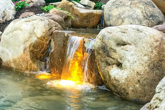 Orange light behind a watefall