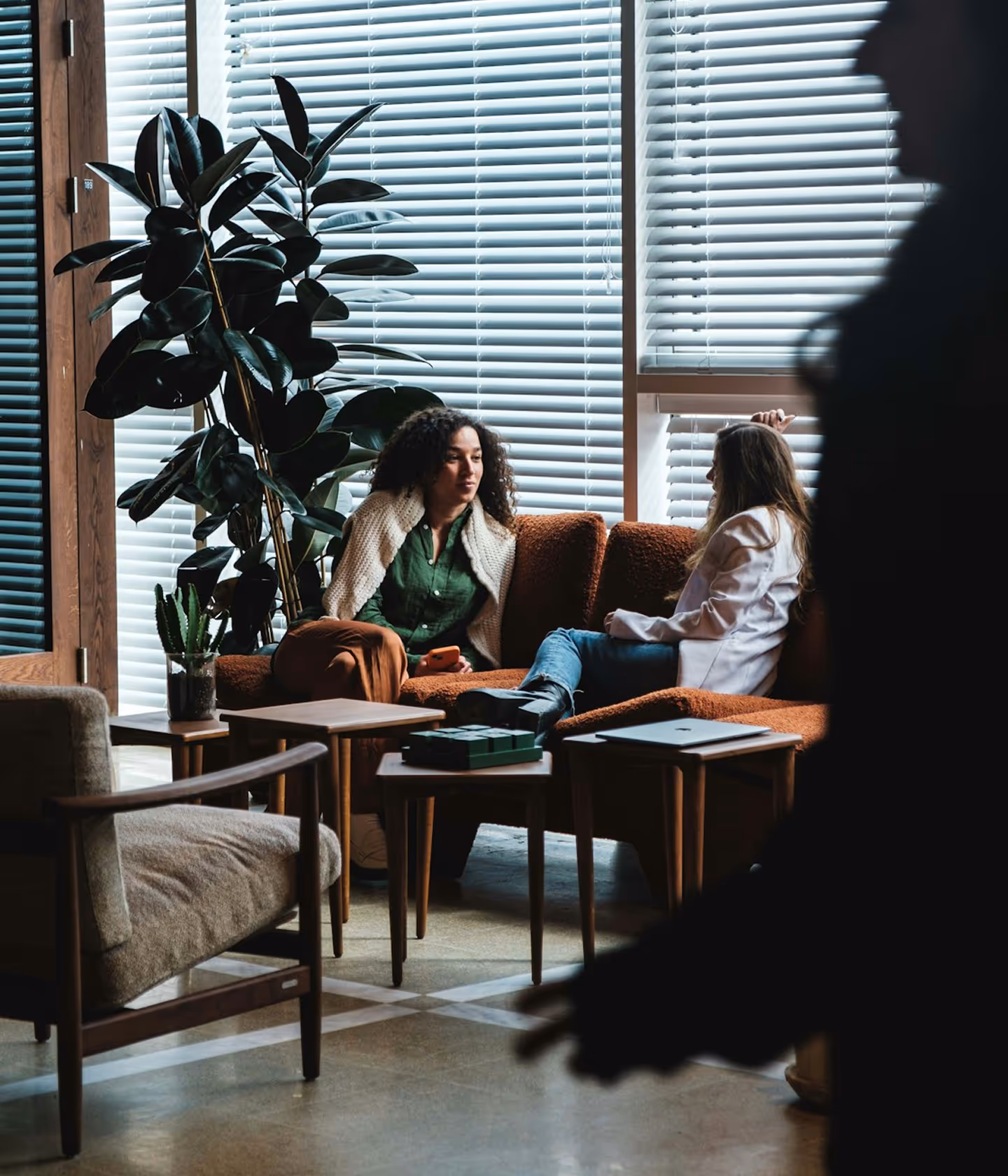 Two women having a talk in a sofa