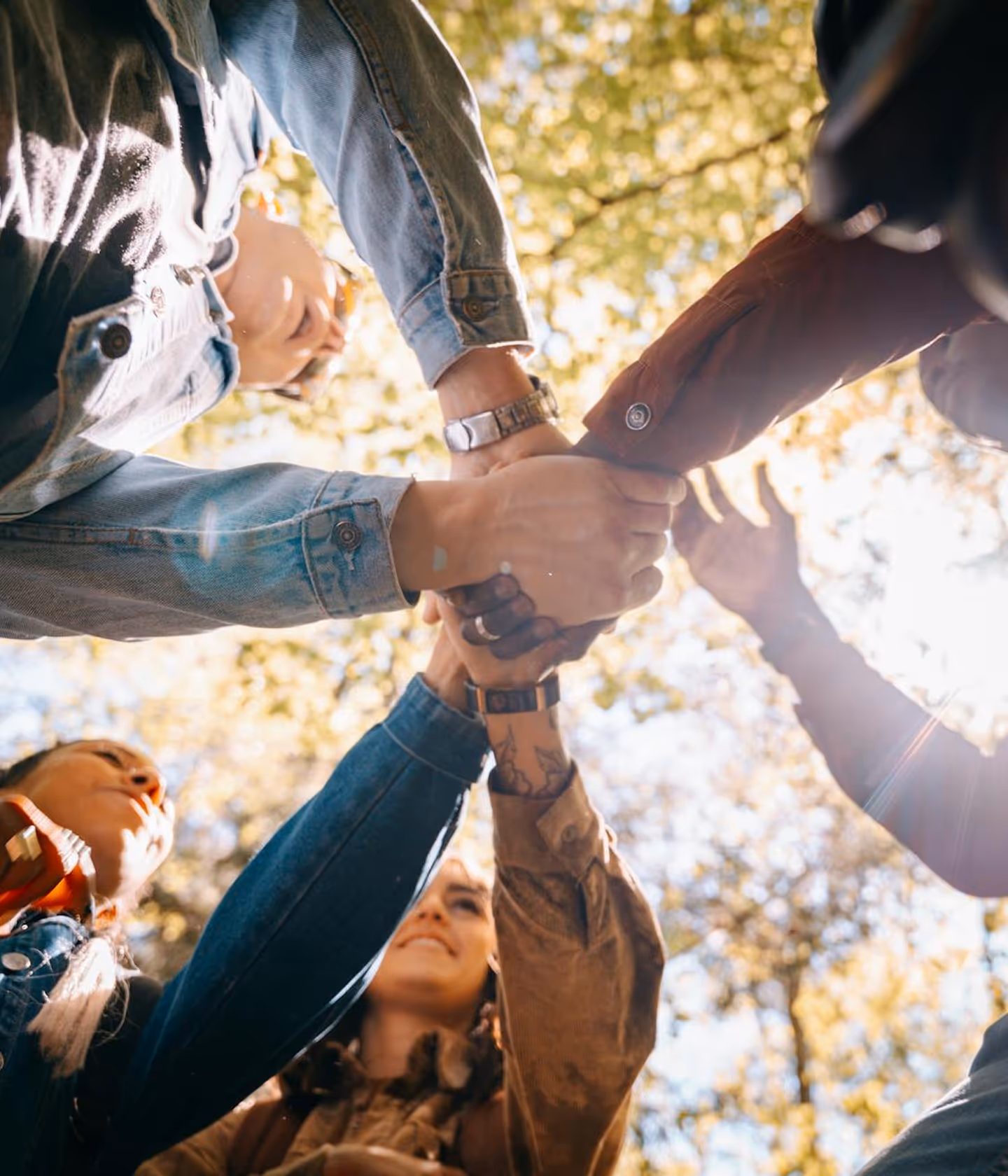 an image of people putting hands together