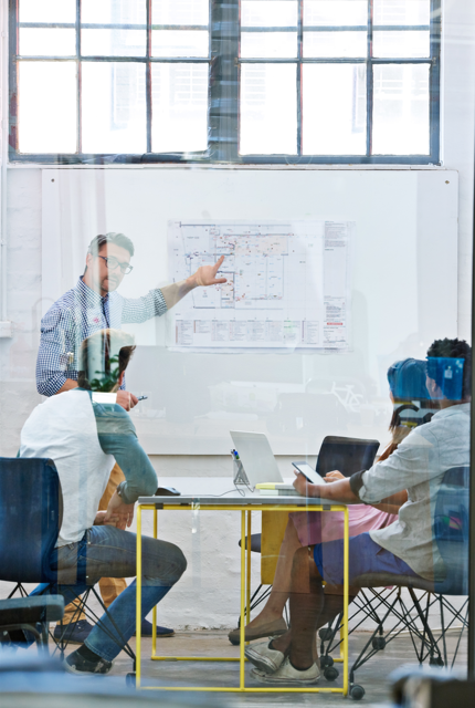 image depicting employees collaborating (for a manufacturing plant)