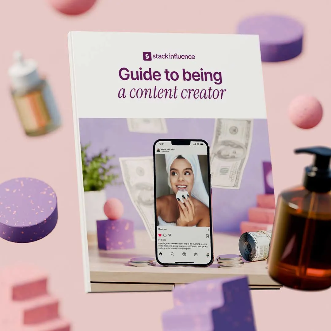 Cover of a guide titled 'Guide to being a content creator' by Stack Influence, showing a smartphone with a smiling woman holding a skincare product and floating dollar bills around.