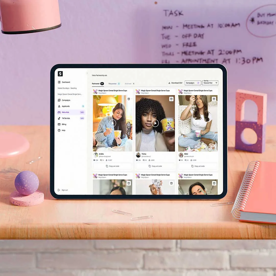 Tablet on a wooden desk displaying a dashboard with Meta Partnership ads featuring various people holding cereal cups.