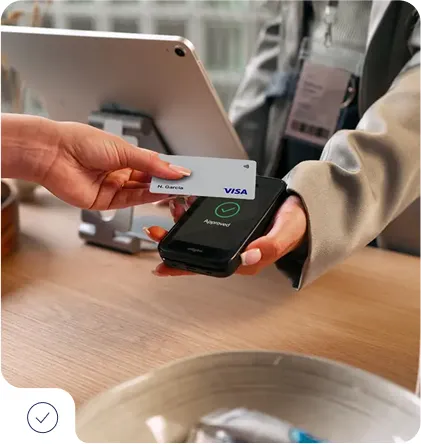 Customer paying for Aspen and Vail taxi service with contactless credit card at mobile payment terminal