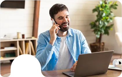 Man calling to book a Vail or Aspen taxi service from his laptop at home