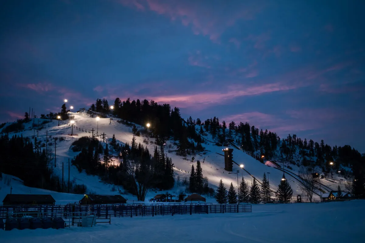Snow-covered ski resort in Colorado illuminated at dusk with scenic mountain views