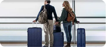 Couple at Denver International Airport with luggage waiting for airport car service pickup